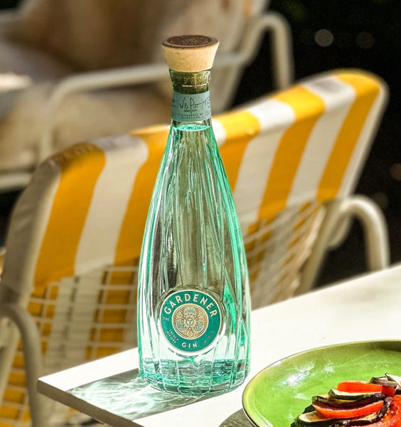 a bottle of The Gardener gin on a table outdoor summer