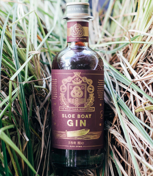 a bottle of Boatyard Sloe Boat Gin on the grass
